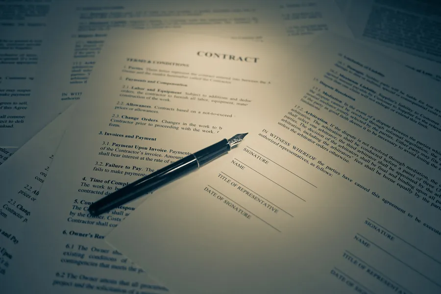 Legal paperwork and a pen on a desk at the Eviction Law Office in Lexington, Kentucky.